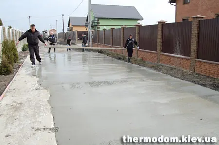 Готовый участок бетонной дороги между домами